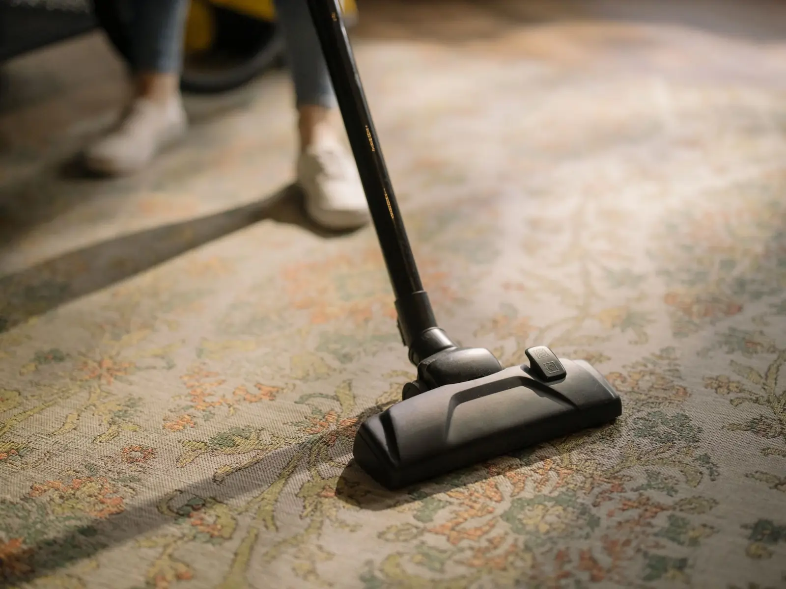 A vacuum cleaner on a patterned rug